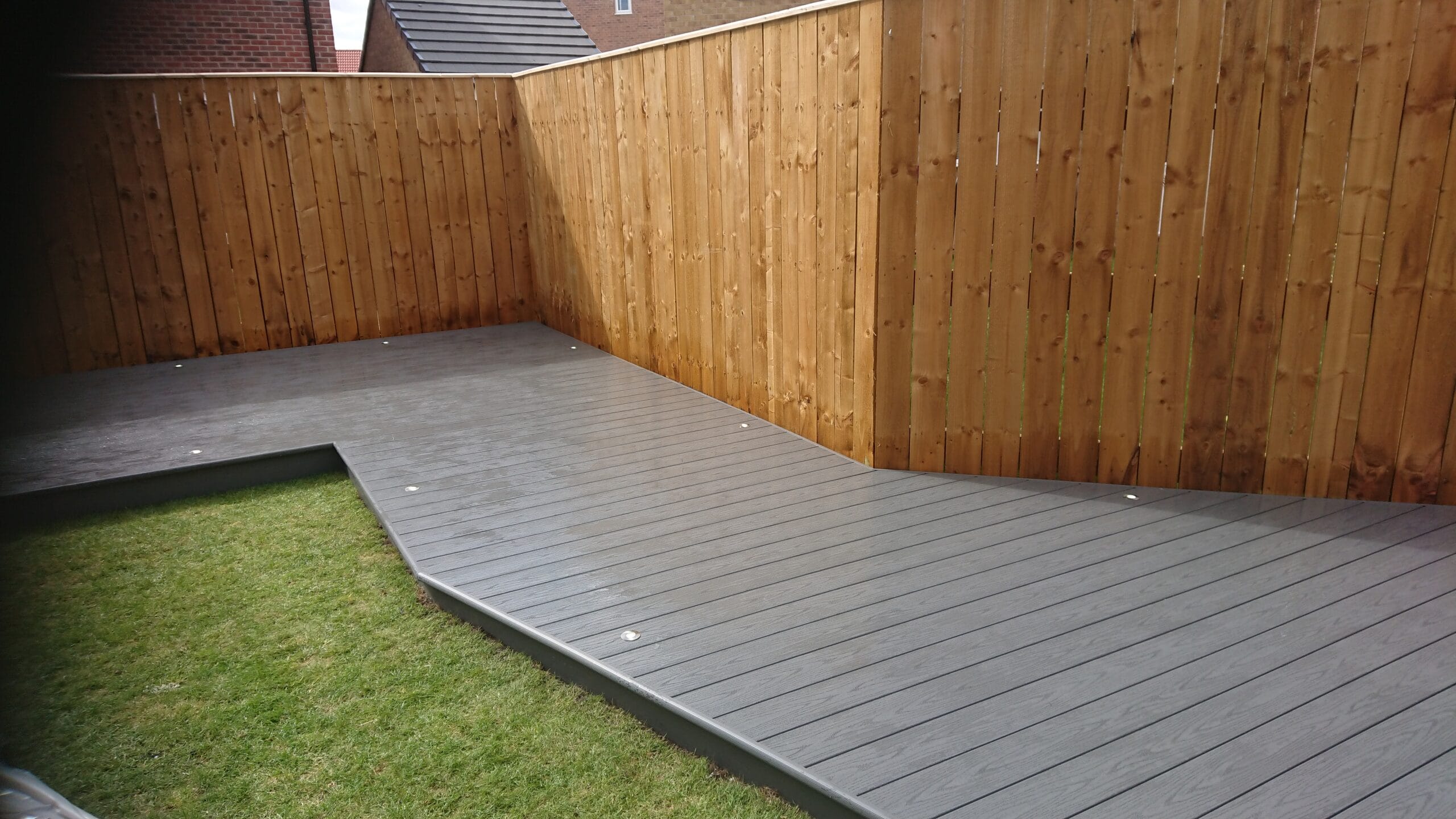 Decking detail showing boards, edge treatment and surrounding garden